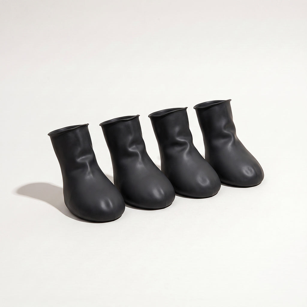 Four black rubber dog paw covers