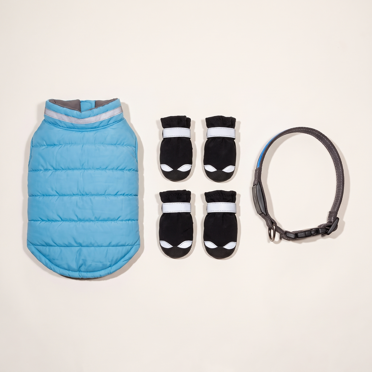 Winter Night Walk Kit laid out: winter jacket, four reflective boots and LED collar