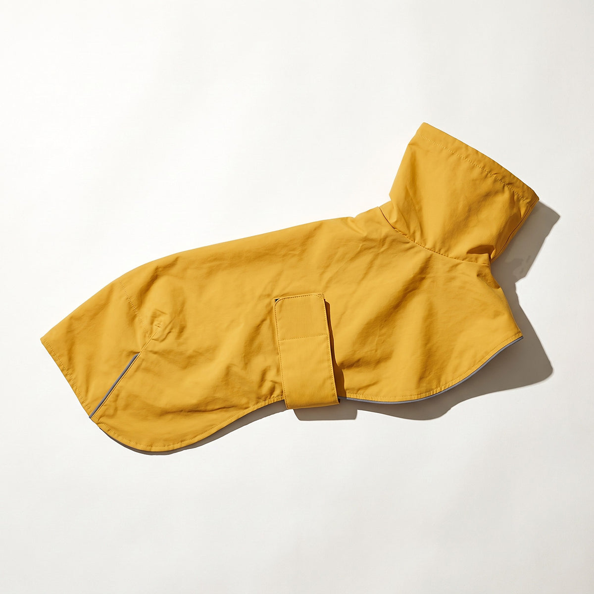 Yellow storm shell jacket laid flat