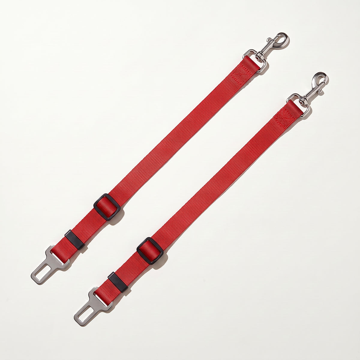 Two red dog car seat belt tethers