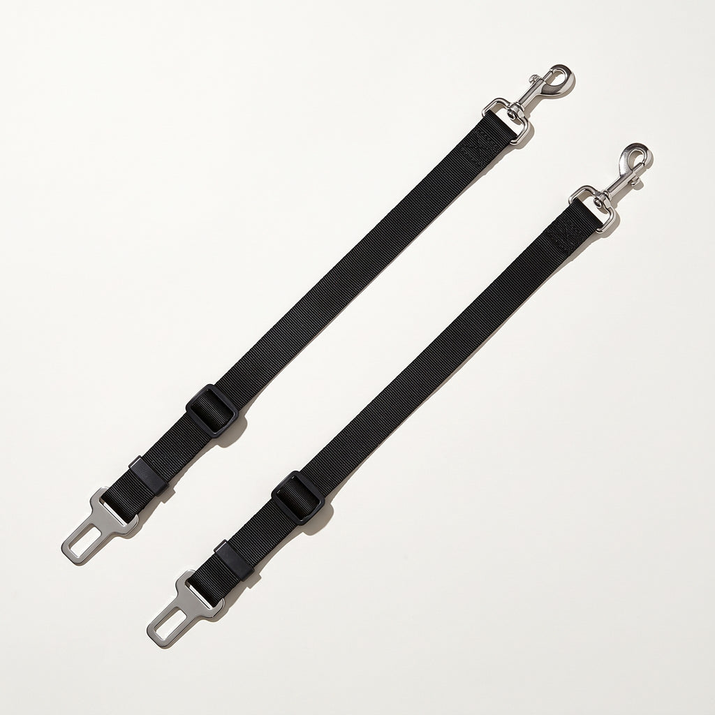 Two black dog car seat belt tethers