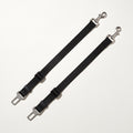 Two black dog car seat belt tethers