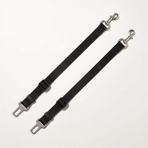 Two black dog car seat belt tethers